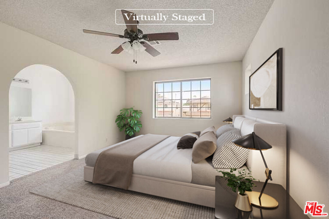 2535 West Ave K9 Lancaster, CA 93536 - Photo 3 of 35 a bedroom with a bed and a chandelier