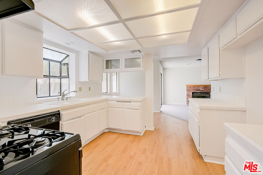 2535 West Ave K9 Lancaster, CA 93536 - Photo 4 of 35 a kitchen with a sink stove and refrigerator