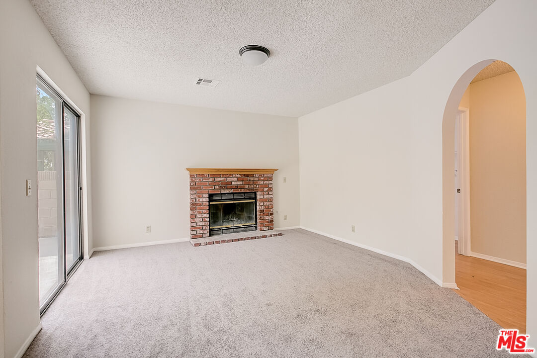 2535 West Ave K9 Lancaster, CA 93536 - Photo 5 of 35 a view of empty room with a fireplace