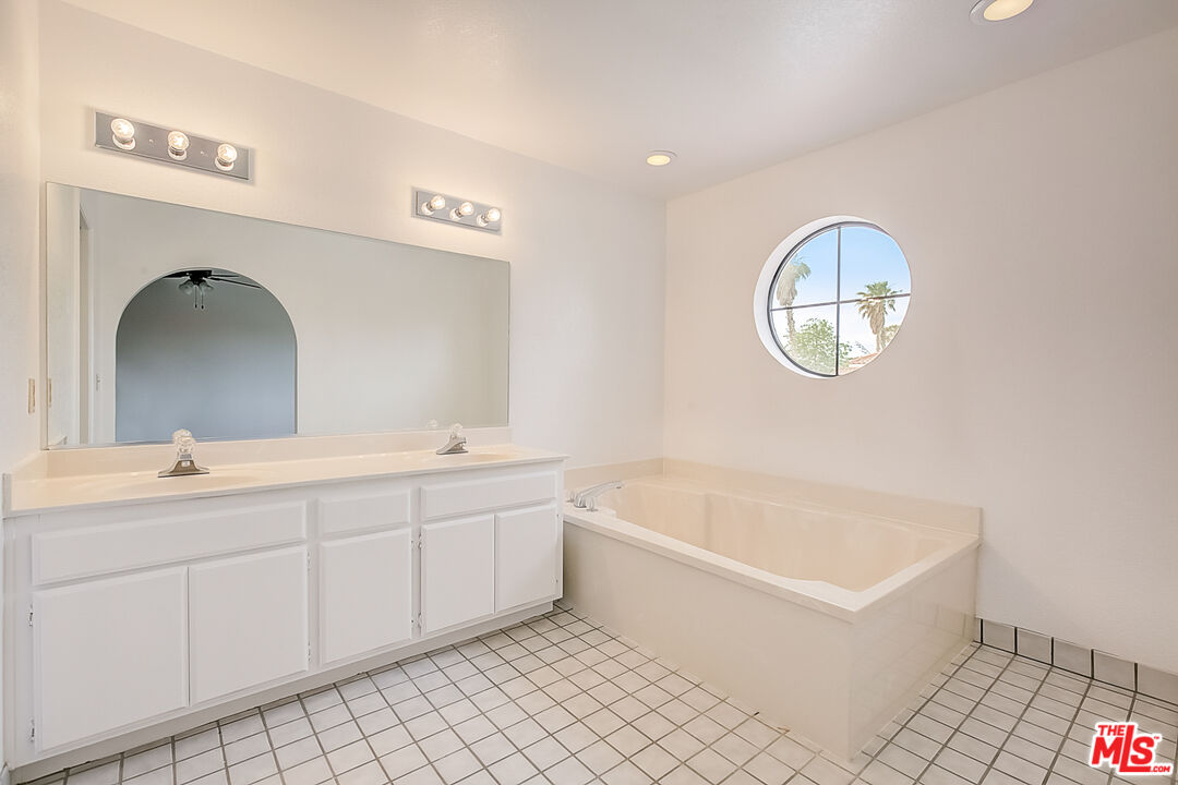 2535 West Ave K9 Lancaster, CA 93536 - Photo 6 of 35 a spacious bathroom with a tub sink and mirror