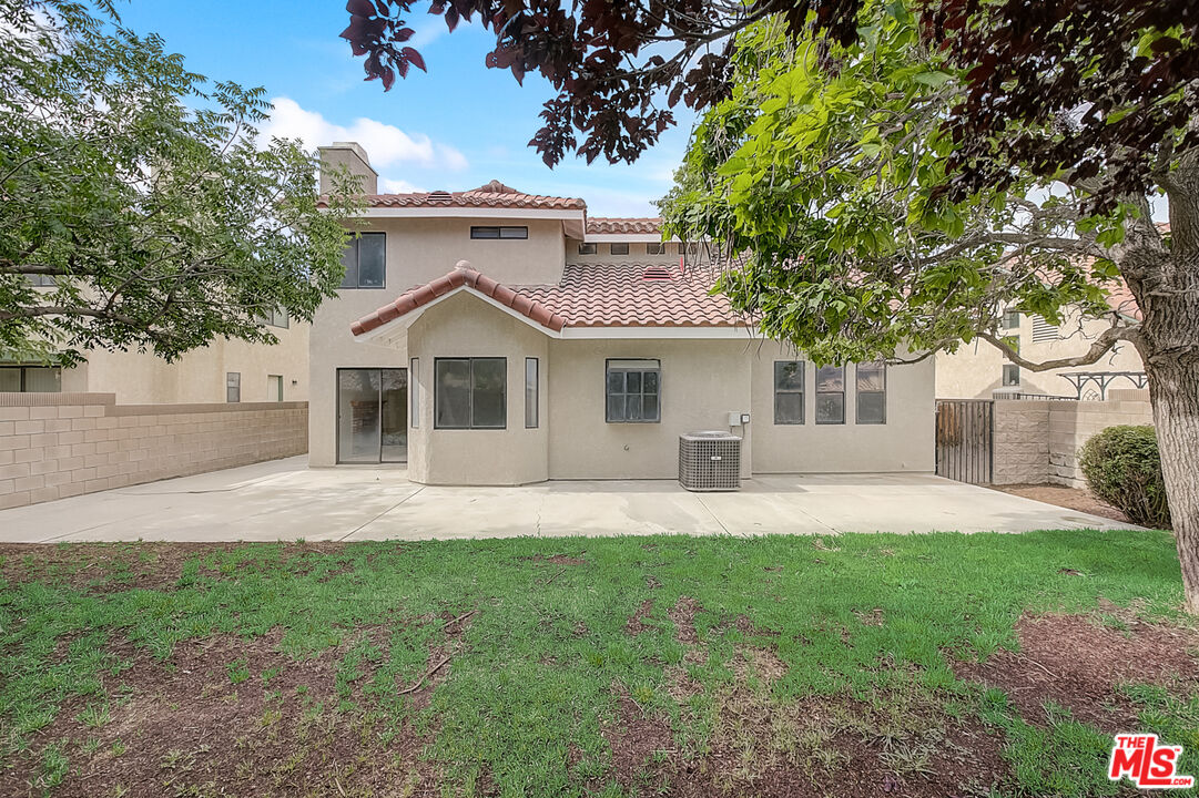 2535 West Ave K9 Lancaster, CA 93536 - Photo 7 of 35 a front view of a house with a garden and yard