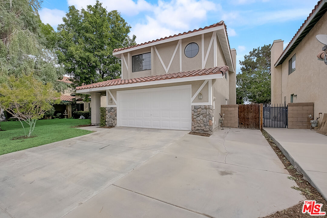 2535 West Ave K9 Lancaster, CA 93536 - Photo 9 of 35 a front view of a house with a garage