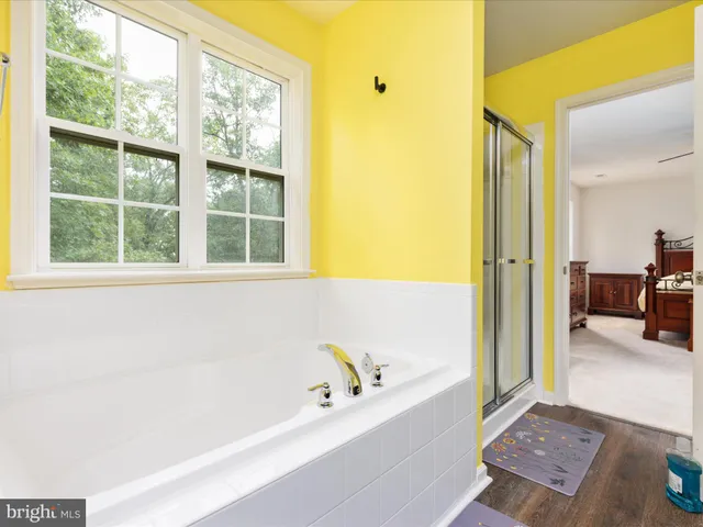 a bathroom with a bathtub and a shower