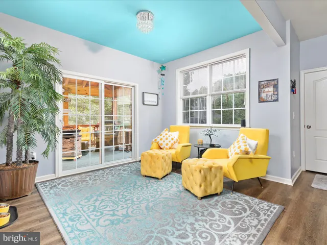 a living room with furniture and a floor to ceiling window