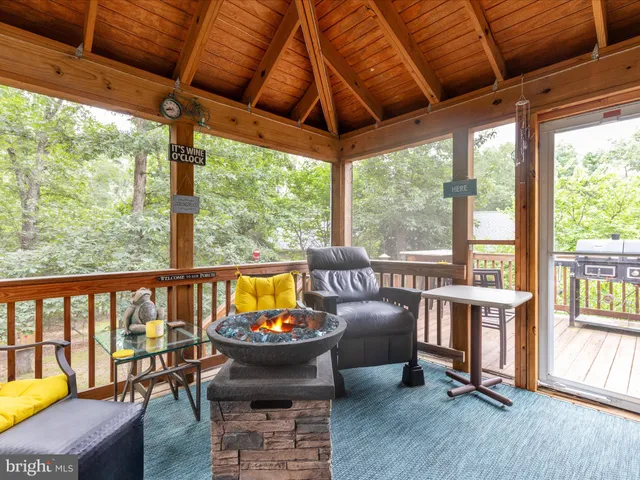 a view of a patio with chairs and wooden floor