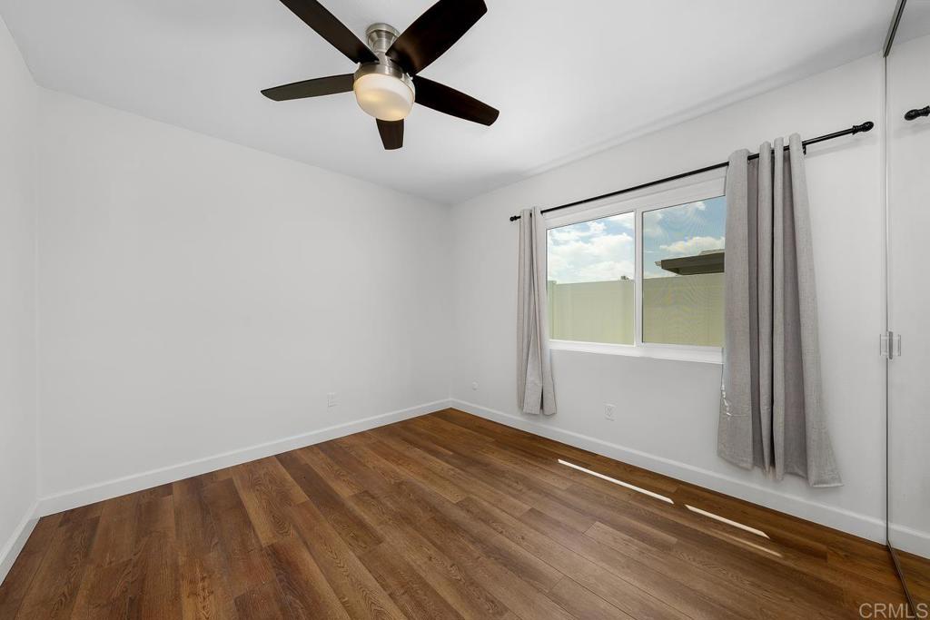10315 Molino Road Santee, CA 92071 - Photo 12 of 19 an empty room with a window and ceiling fan
