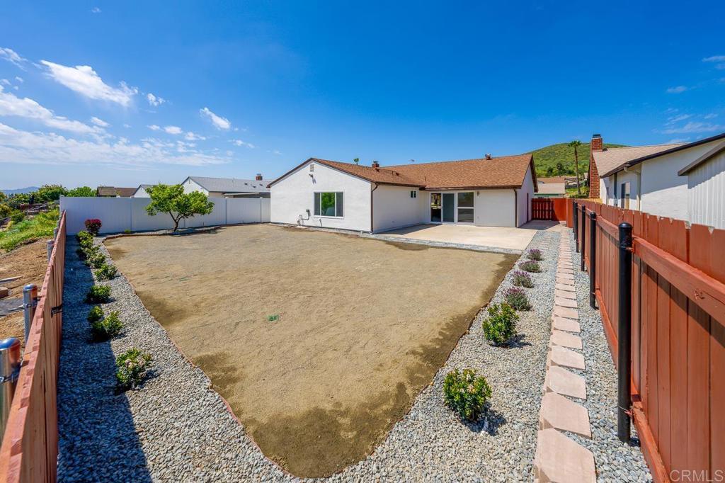 10315 Molino Road Santee, CA 92071 - Photo 18 of 19 a view of a house with a yard and potted plants