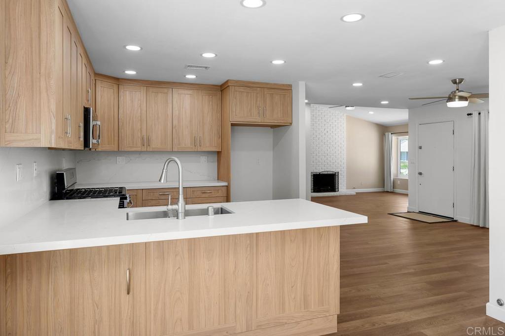 10315 Molino Road Santee, CA 92071 - Photo 4 of 19 a kitchen with stainless steel appliances granite countertop a sink refrigerator and a stove