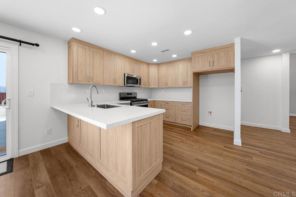 10315 Molino Road Santee, CA 92071 - Photo 5 of 19 a kitchen with a sink a counter top space and cabinets