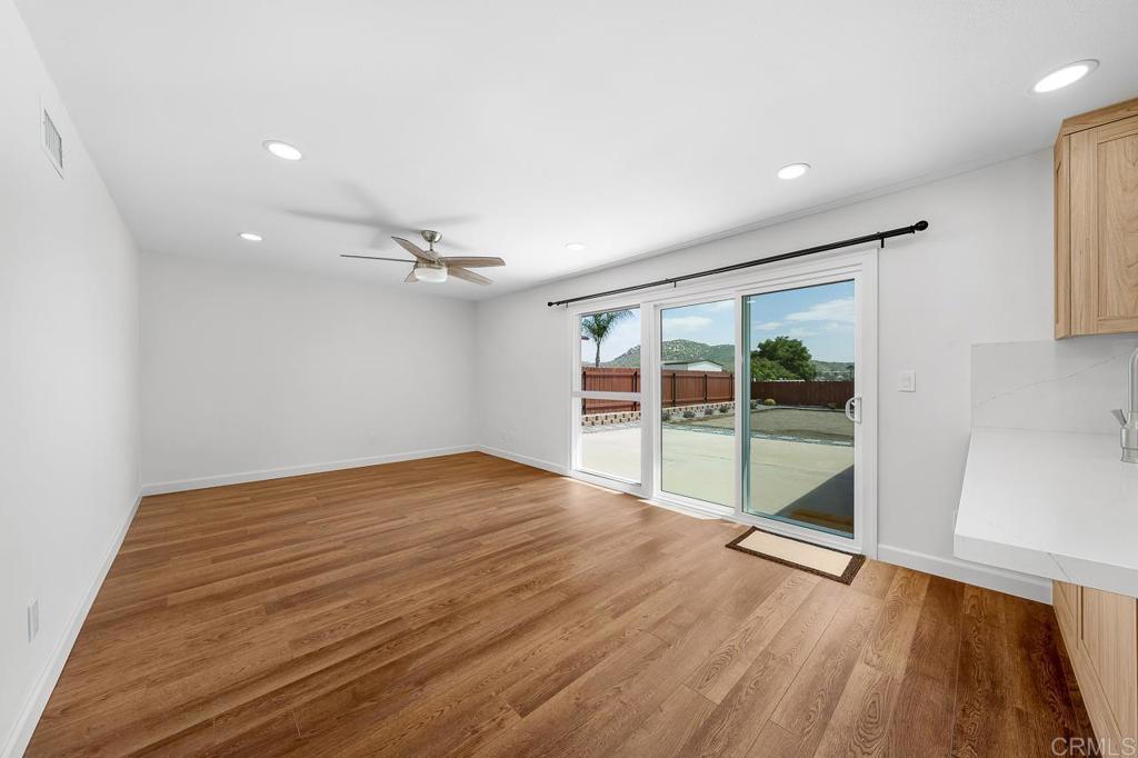 10315 Molino Road Santee, CA 92071 - Photo 8 of 19 an empty room with wooden floor and glass door