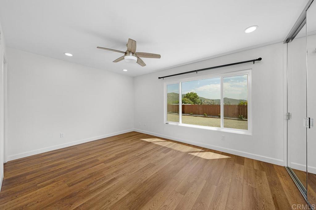 10315 Molino Road Santee, CA 92071 - Photo 9 of 19 a view of an empty room with a window and wooden floor