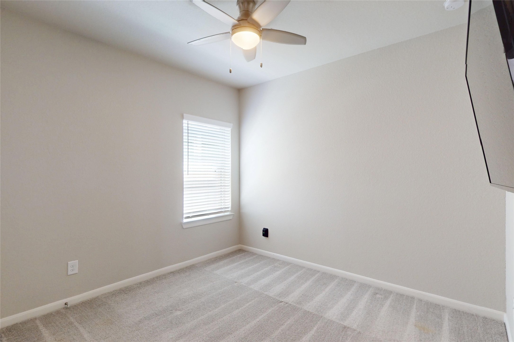 21586 Jordan Pond Ridge Porter, TX 77365 - Photo 21 of 30 This other secondary bedroom also has a lighted ceiling fan and a mounted TV that stays!