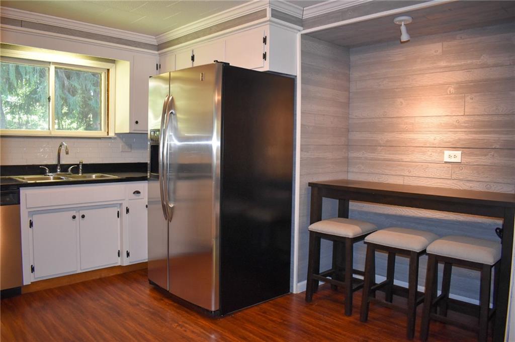 1039 Smithfield Road Smithfield, PA 15478 - Photo 4 of 16 a kitchen with stainless steel appliances a refrigerator and wooden floor