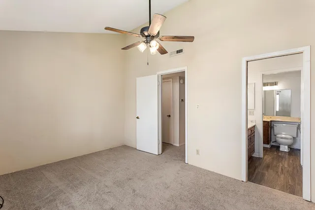 a view of a room with a hanging light and closet