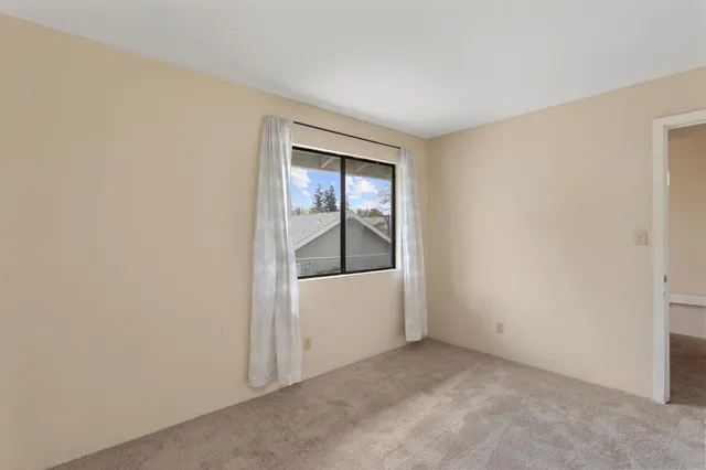 an empty room with a empty space and window