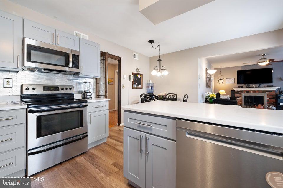 73 Red Hill Road Manchester Township, NJ 08759 - Photo 11 of 25 a kitchen with stainless steel appliances a stove microwave and sink