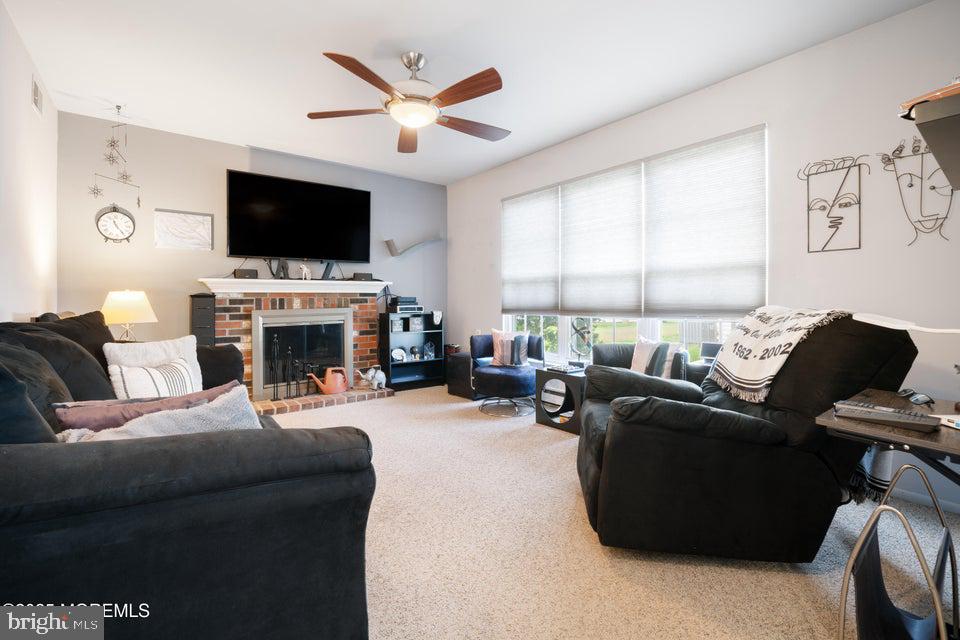 73 Red Hill Road Manchester Township, NJ 08759 - Photo 14 of 25 a living room with furniture a flat screen tv and a fireplace