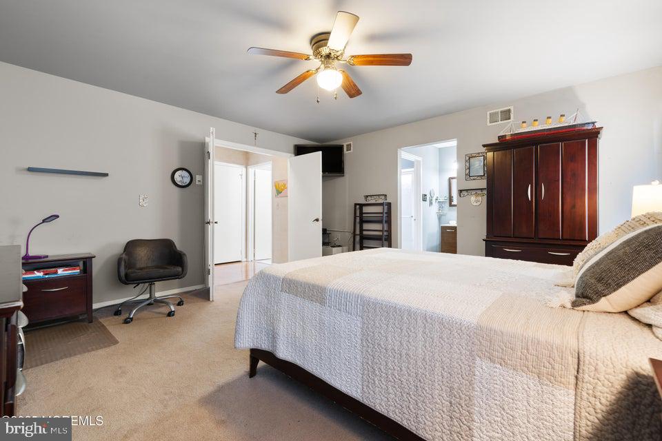 73 Red Hill Road Manchester Township, NJ 08759 - Photo 21 of 25 a bedroom with a bed and a chandelier