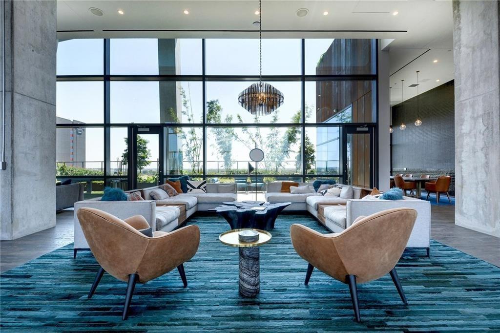 70 Rainey Street, Unit 1409 Austin, TX 78701 - Photo 26 of 38 Common area with floor to ceiling windows and a high ceiling