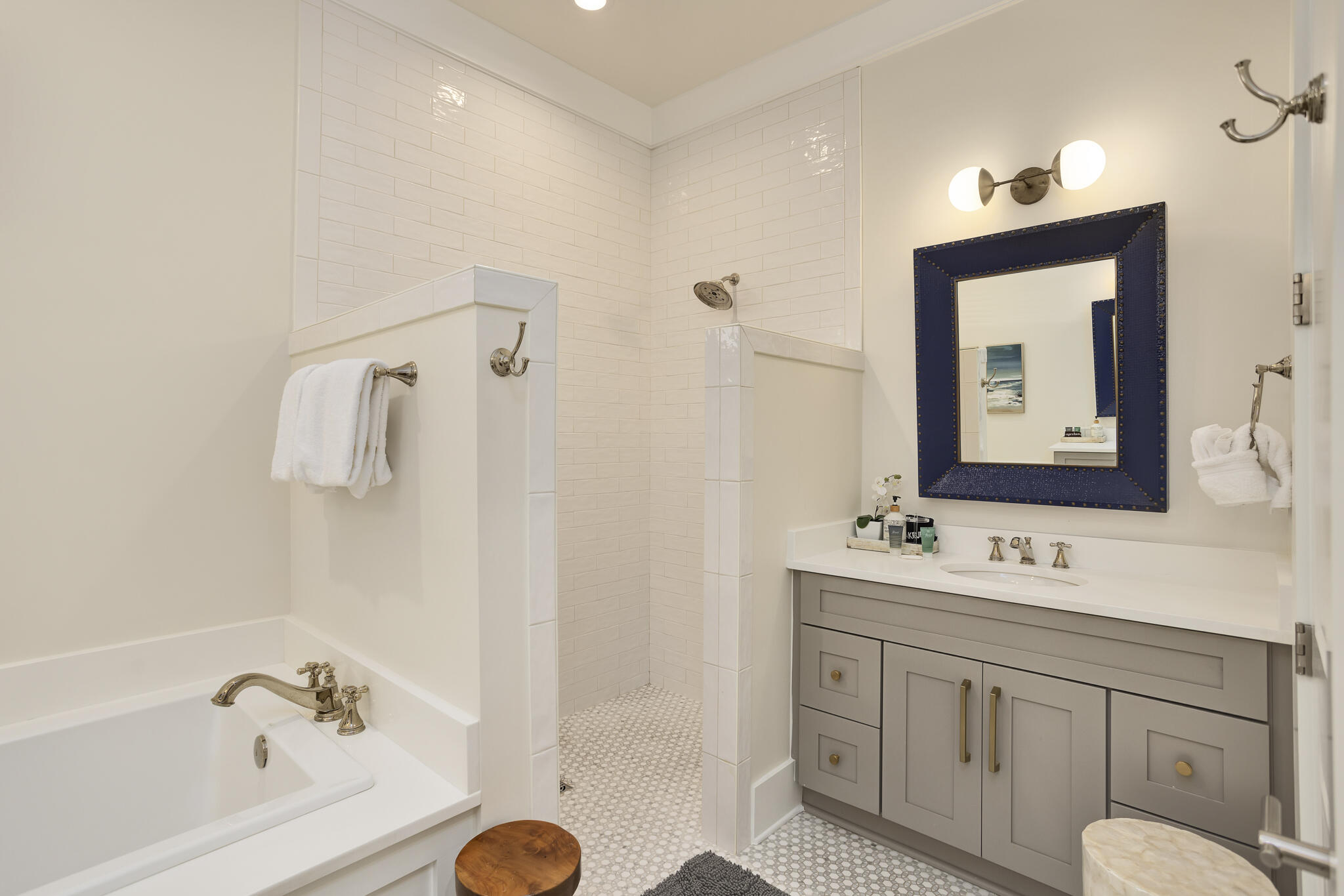 60 Blue Lake Road Santa Rosa Beach, FL 32459 - Photo 22 of 39 a bathroom with a tub sink and mirror