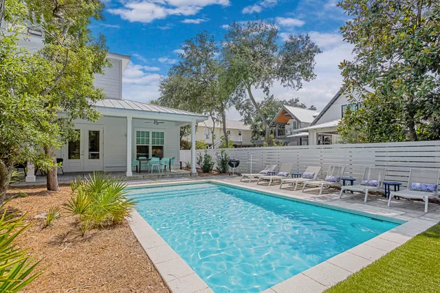 a large white kitchen with a large island