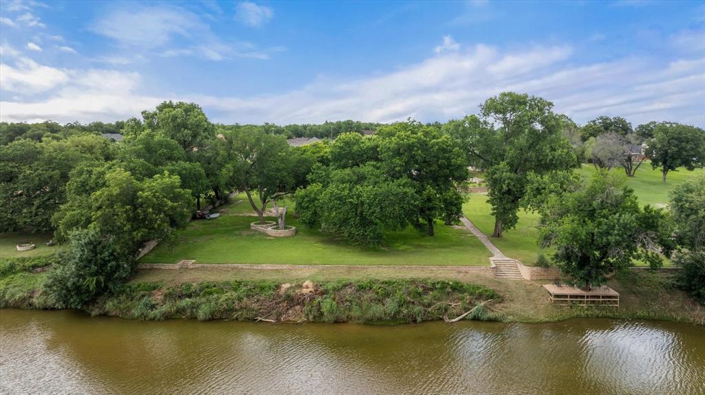 9404 Bellechase Road Granbury, TX 76049 - Photo 4 of 37 a view of a lake with houses in the back