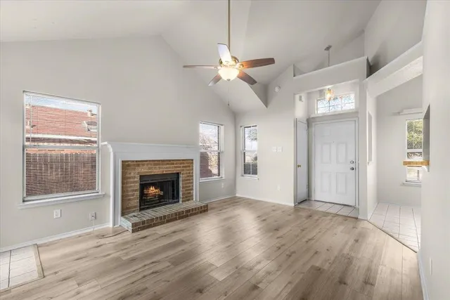 a view of an empty room with window and fire place