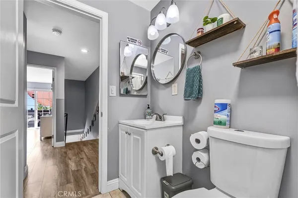a bathroom with a sink a toilet and a mirror