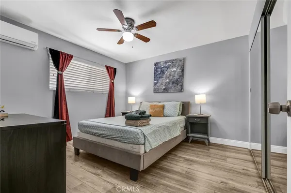 a bedroom with a bed and a chandelier