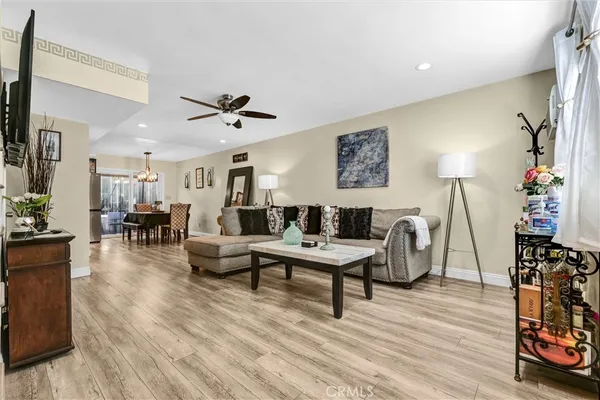 a living room with furniture and a wooden floor