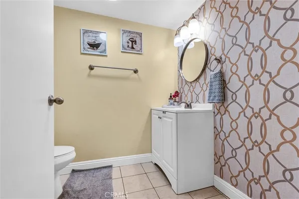 a bathroom with a sink mirror vanity and toilet