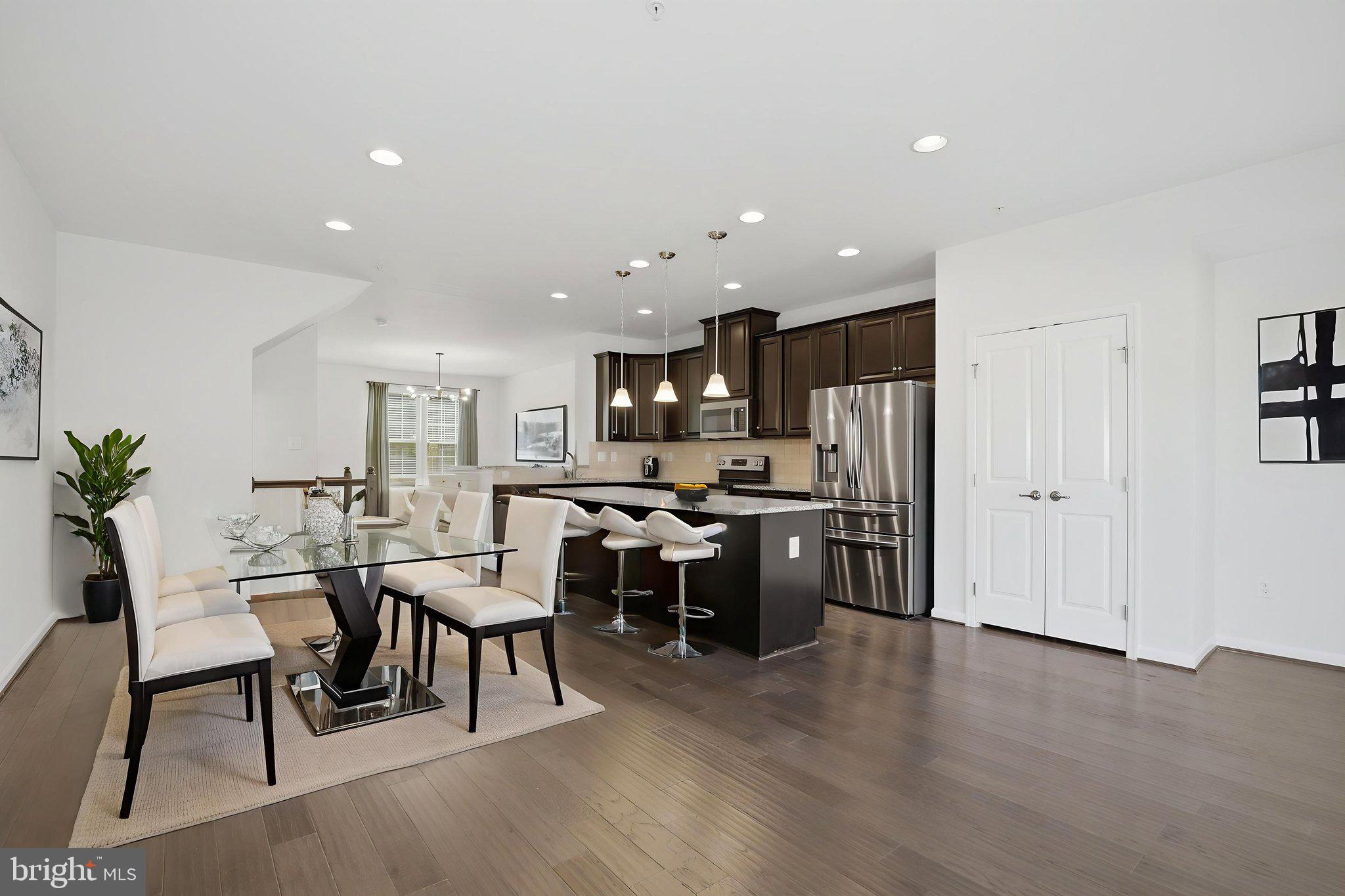 2784 Fredericksburg Road Hanover, MD 21076 - Photo 14 of 60 a kitchen with a dining table chairs appliances and cabinets