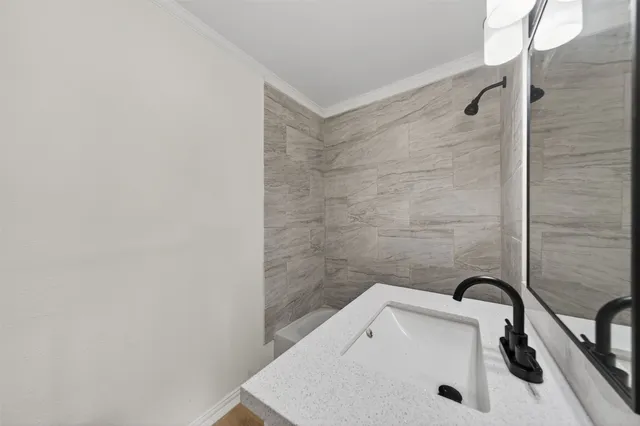 a bathroom with a white bath tub and a sink
