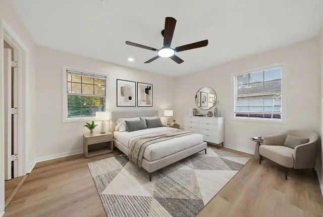 a bedroom with a large bed couch and a window