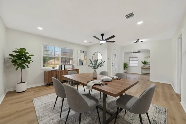 a view of a dining room with furniture and a potted plant