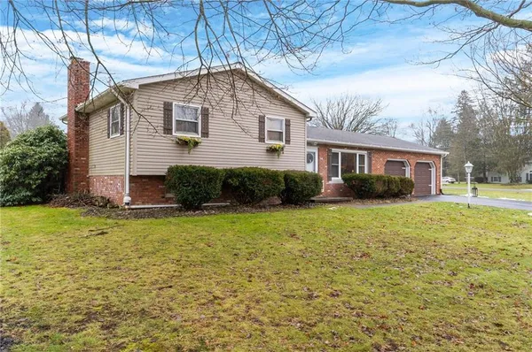 a front view of a house with a garden