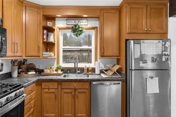 a kitchen with stainless steel appliances granite countertop a refrigerator and a sink