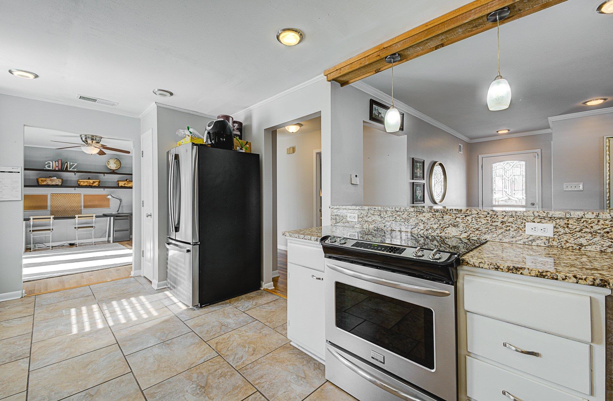 5661 Barfield Road Memphis, TN 38120 - Photo 13 of 31 Kitchen with stainless steel appliances, white cabinetry, ceiling fan, and pendant lighting