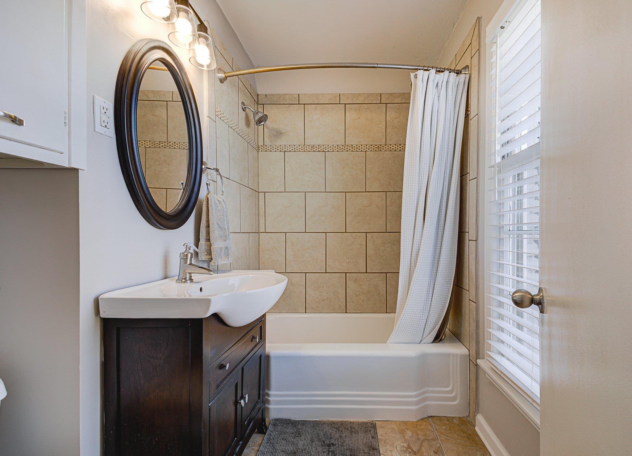 5661 Barfield Road Memphis, TN 38120 - Photo 19 of 31 Bathroom with shower / tub combo, vanity, and tile patterned flooring