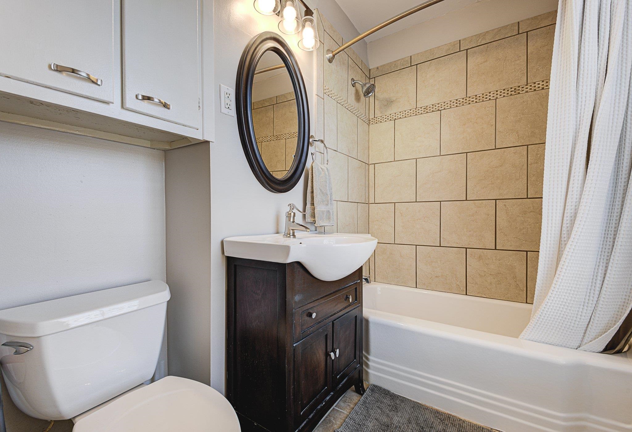 5661 Barfield Road Memphis, TN 38120 - Photo 20 of 31 Full bathroom featuring toilet, shower / bath combination with curtain, and vanity