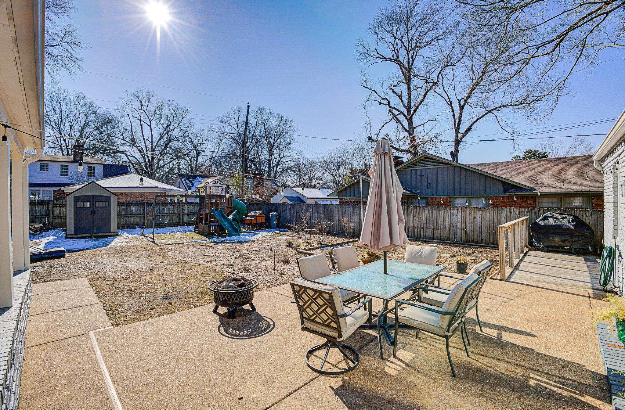 5661 Barfield Road Memphis, TN 38120 - Photo 26 of 31 View of patio / terrace with a fire pit, a playground, and a storage unit