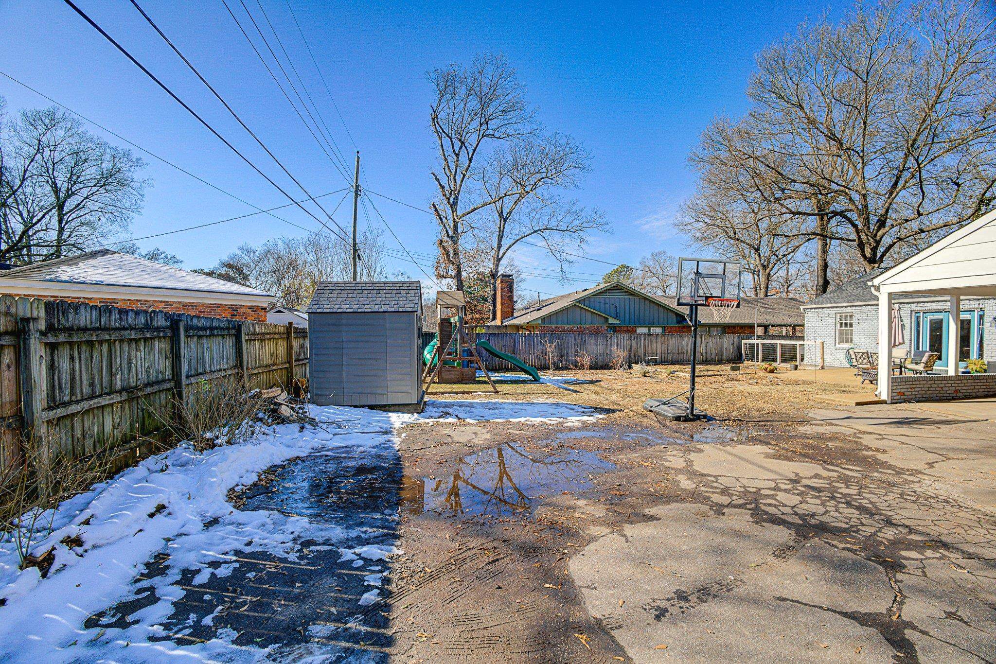 5661 Barfield Road Memphis, TN 38120 - Photo 29 of 31 Yard covered in snow with a playground and a shed