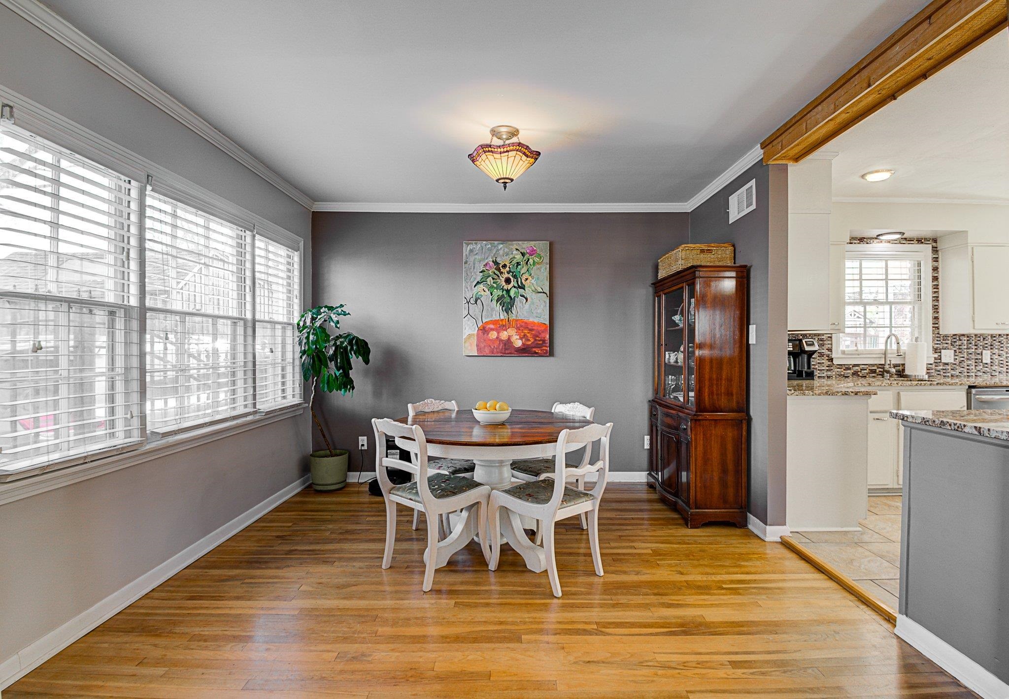 5661 Barfield Road Memphis, TN 38120 - Photo 6 of 31 Dining space with crown molding, light hardwood / wood-style flooring, a wealth of natural light, and sink