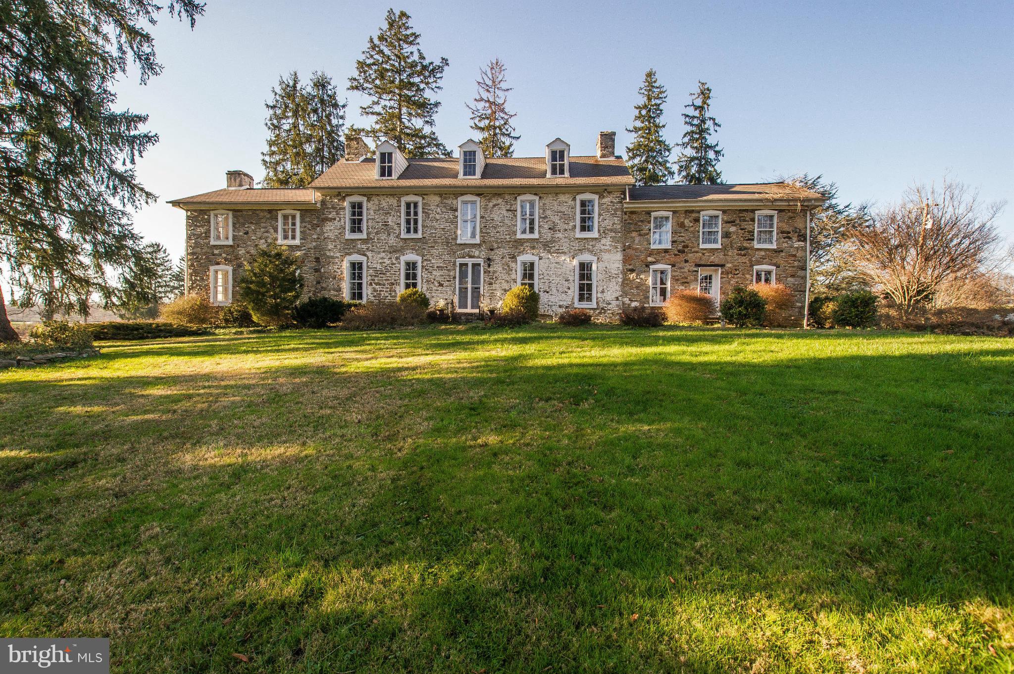 a view of a big yard with a house in the background