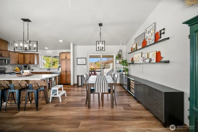a view of a dining room with furniture a chandelier and wooden floor