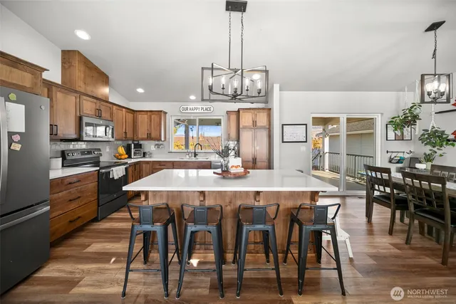 a large kitchen with a dining table and chairs