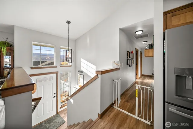 a view of a living room with furniture and windows