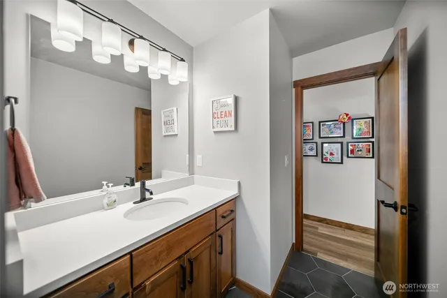 a bathroom with a sink vanity and a mirror
