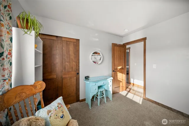 a view of a livingroom with furniture and a window