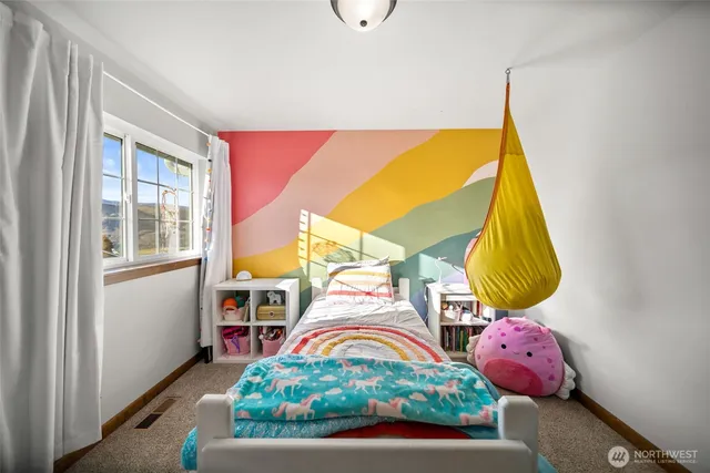 a bedroom with a bed and a window